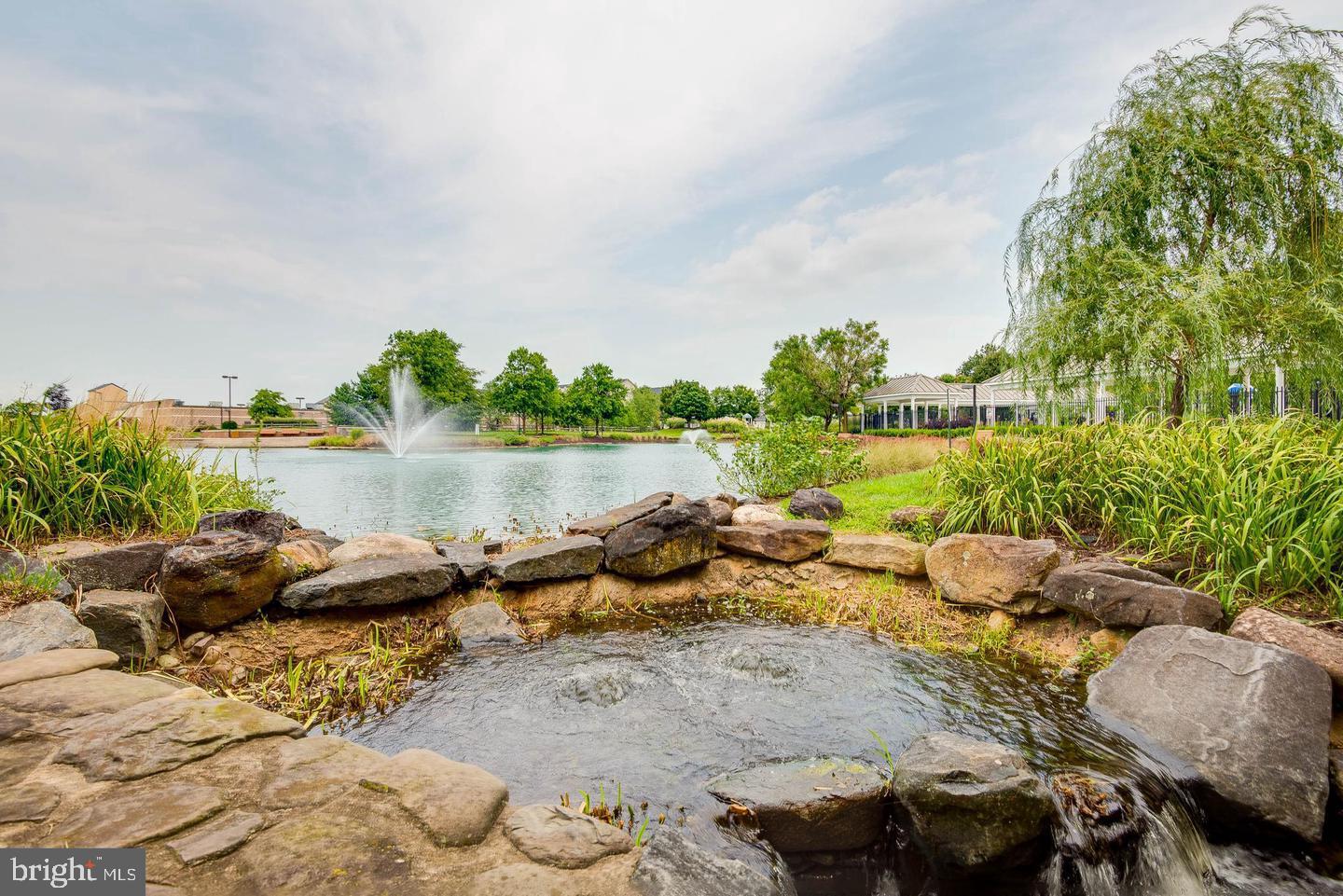 2640 Streamview Drive Odenton, MD 21113 - Photo 58 of 73 a view of a lake with lawn chairs and a dining table