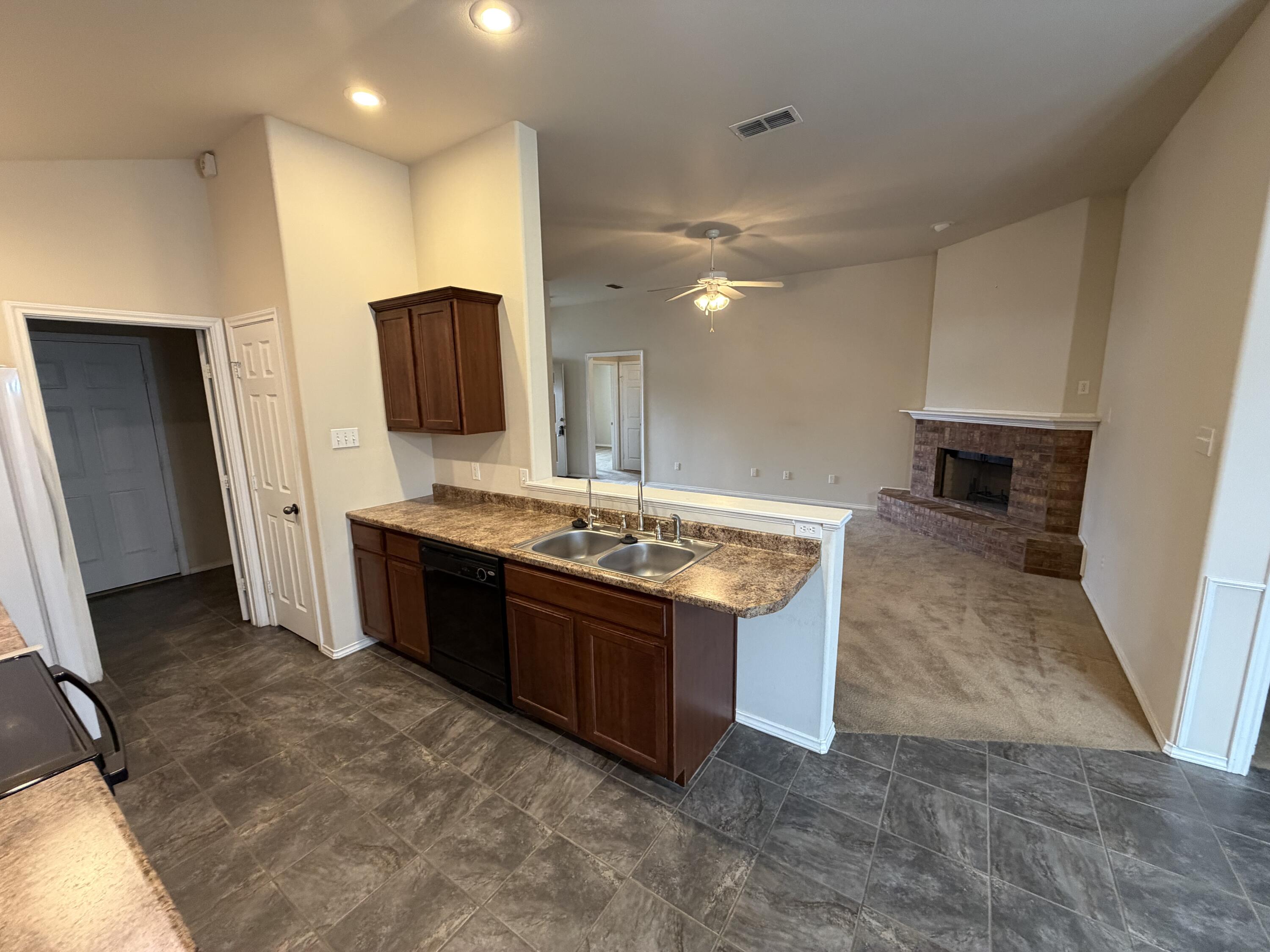 6544 84th Street Lubbock, TX 79424 - Photo 20 of 29 a spacious bathroom with a granite countertop sink and a mirror