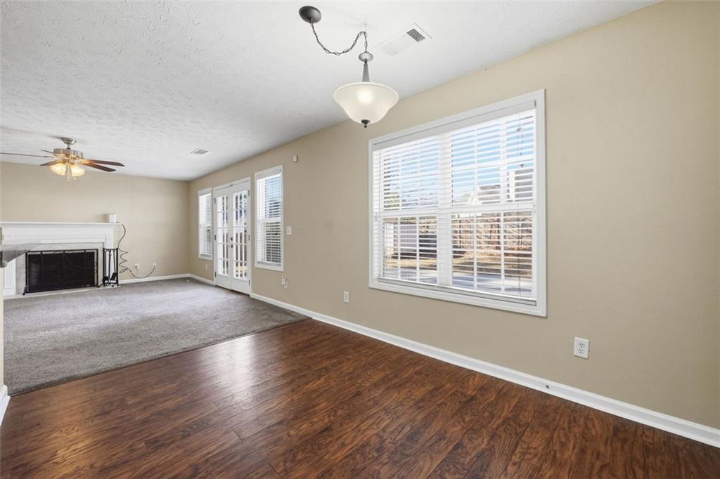 921 Roxeywood Drive Winder, GA 30680 - Photo 22 of 56 a view of an empty room with wooden floor and a window