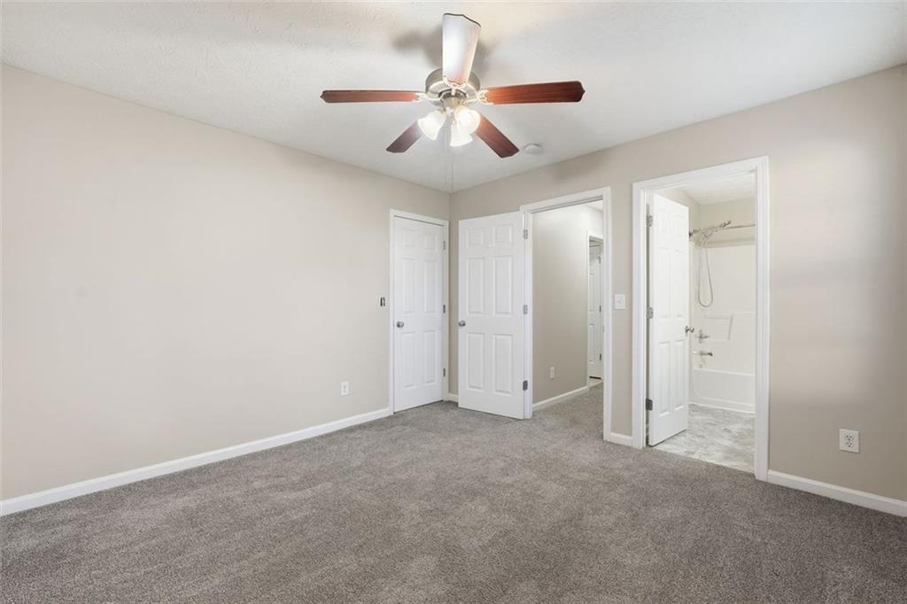 921 Roxeywood Drive Winder, GA 30680 - Photo 30 of 56 an empty room with a ceiling fan and a window