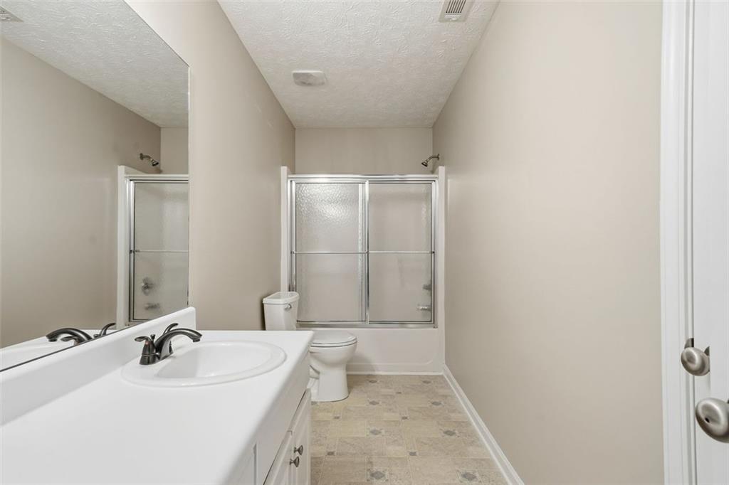 921 Roxeywood Drive Winder, GA 30680 - Photo 37 of 56 a bathroom with a sink a toilet and shower