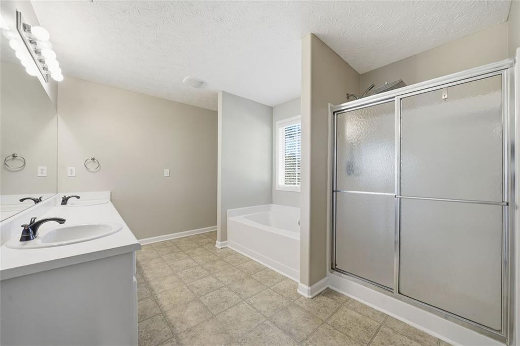 921 Roxeywood Drive Winder, GA 30680 - Photo 45 of 56 a bathroom with a sink vanity and tub
