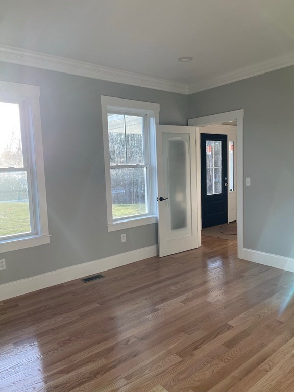 27 Paugus Trail Groton, MA 01450 - Photo 16 of 29 a view of an empty room with wooden floor and a window
