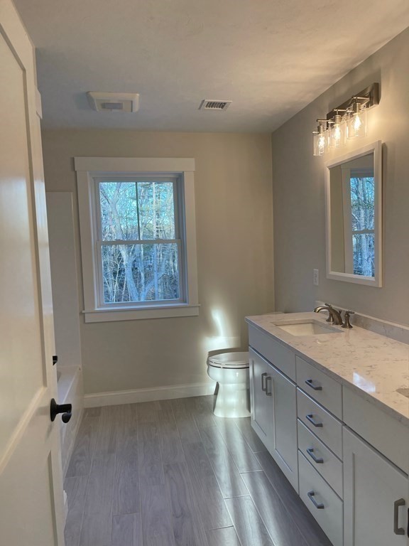 27 Paugus Trail Groton, MA 01450 - Photo 19 of 29 a bathroom with a granite countertop sink a mirror and a window