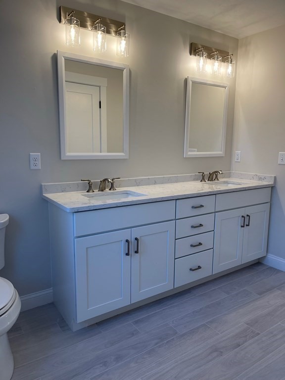27 Paugus Trail Groton, MA 01450 - Photo 20 of 29 a bathroom with a double vanity sink and mirror with toilet