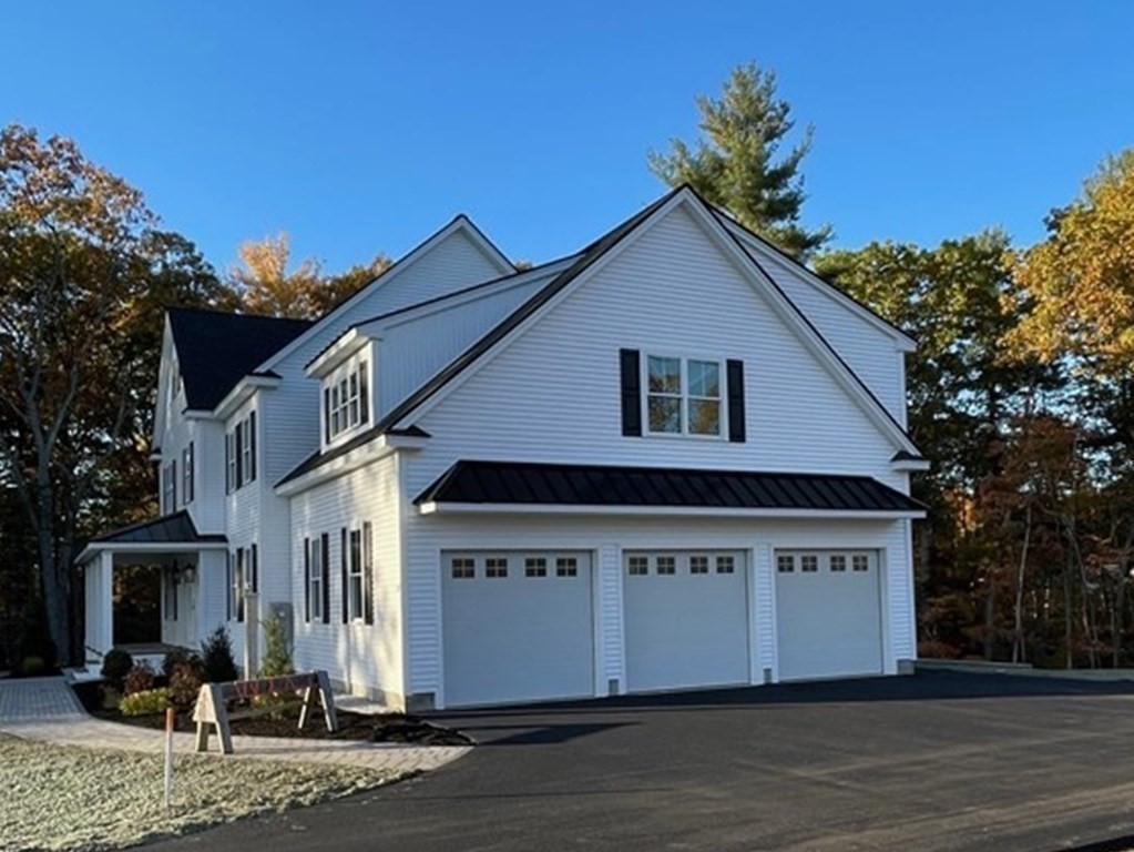 27 Paugus Trail Groton, MA 01450 - Photo 3 of 29 a view of a white house with a yard and potted plants