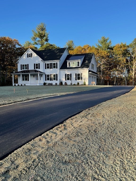 27 Paugus Trail Groton, MA 01450 - Photo 6 of 29 a front view of a house with a yard