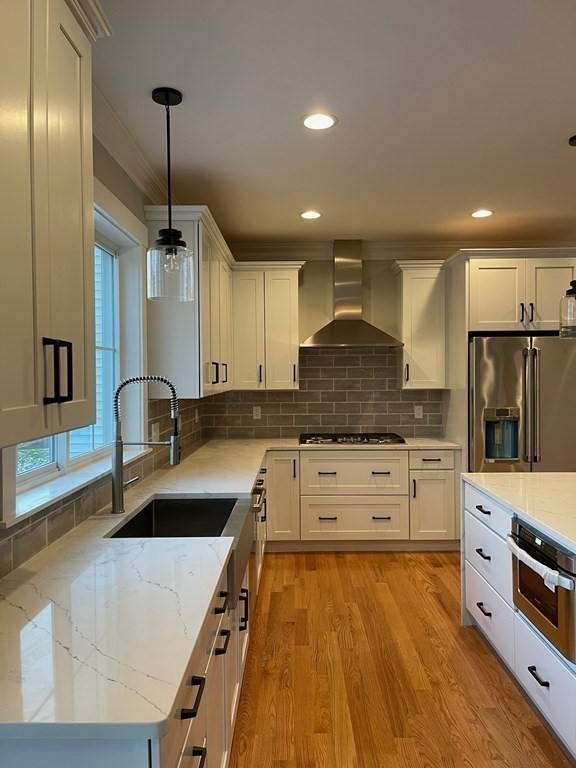 27 Paugus Trail Groton, MA 01450 - Photo 7 of 29 a large kitchen with granite countertop a stove oven and white cabinets