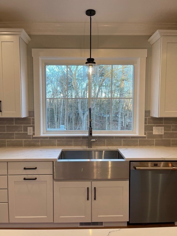 27 Paugus Trail Groton, MA 01450 - Photo 9 of 29 a kitchen with a sink and large window