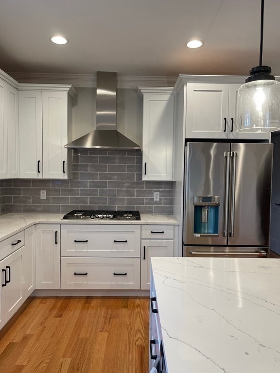 27 Paugus Trail Groton, MA 01450 - Photo 10 of 29 a kitchen with stainless steel appliances granite countertop a refrigerator a stove and a sink with wooden floor