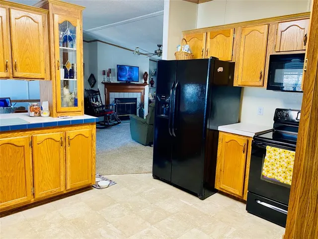 a kitchen with stainless steel appliances granite countertop a refrigerator and a stove