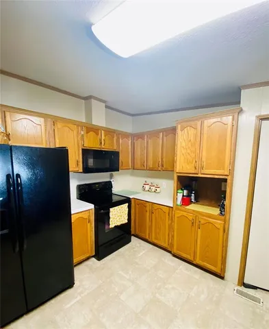 a kitchen with stainless steel appliances granite countertop a refrigerator and a stove top oven