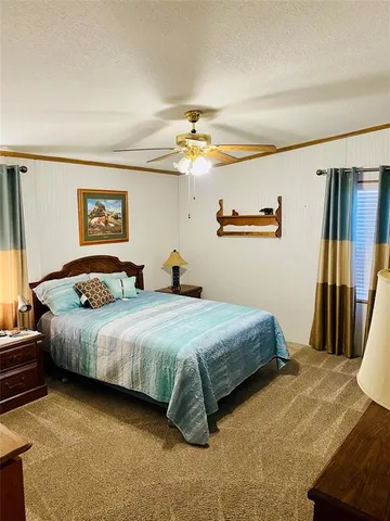 a bedroom with bed and wooden floor