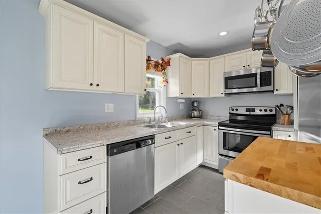 a kitchen with granite countertop a sink and cabinets