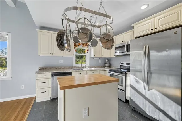 a view of a dining room with furniture a chandelier and wooden floor