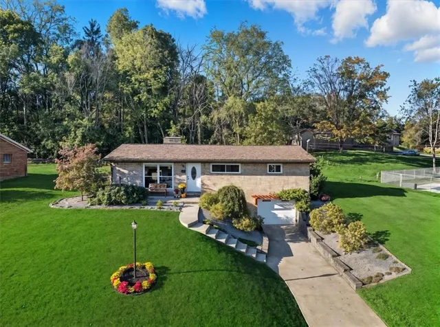 a view of a house with a garden and deck
