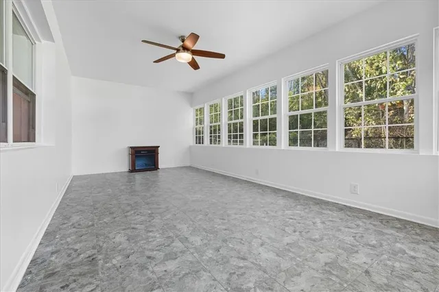 a view of a patio with table and chairs and potted plants