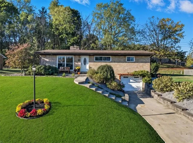 a view of a house with a backyard and a patio