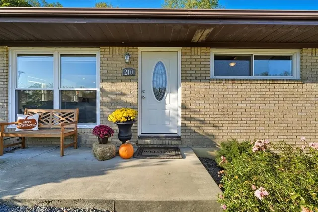 a backyard of a house with dining table and chairs