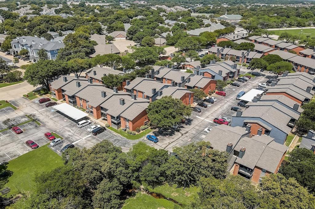 an aerial view of residential house with outdoor space and trees all around