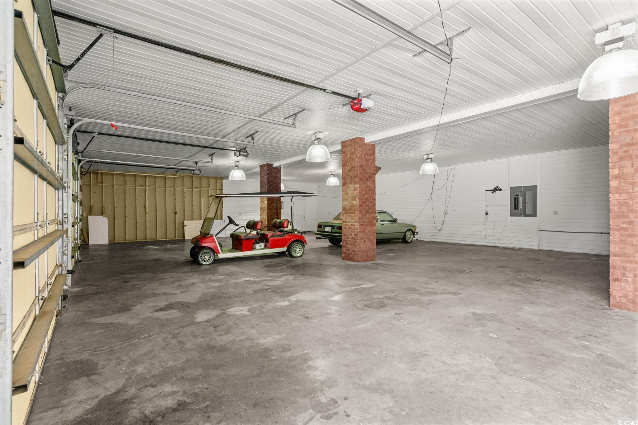 6912 Bay Road Myrtle Beach, SC 29588 - Photo 27 of 38 Garage featuring metal wall and a garage door opener