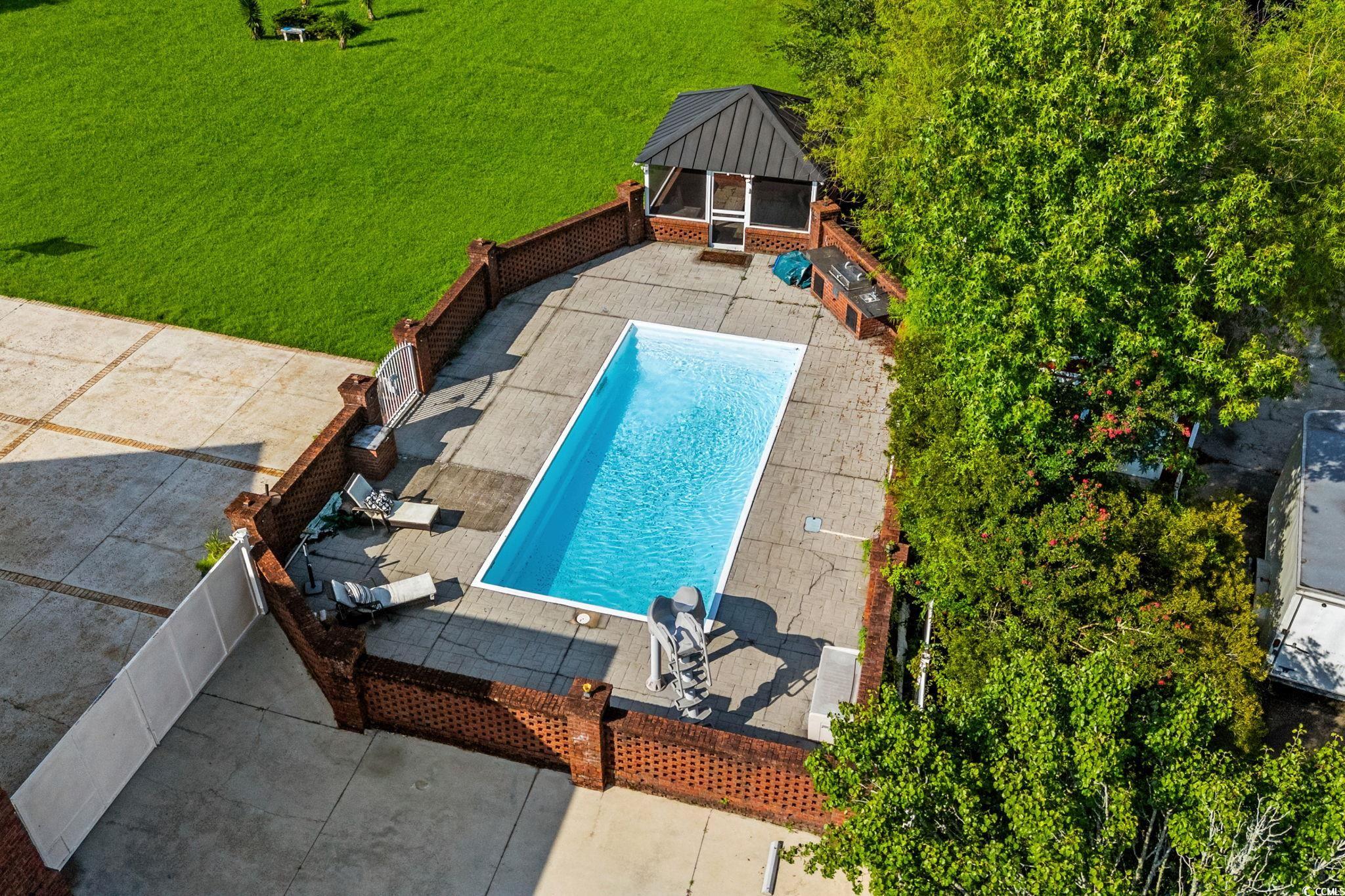 6912 Bay Road Myrtle Beach, SC 29588 - Photo 33 of 38 Outdoor pool with a gazebo, a lawn, and a patio area