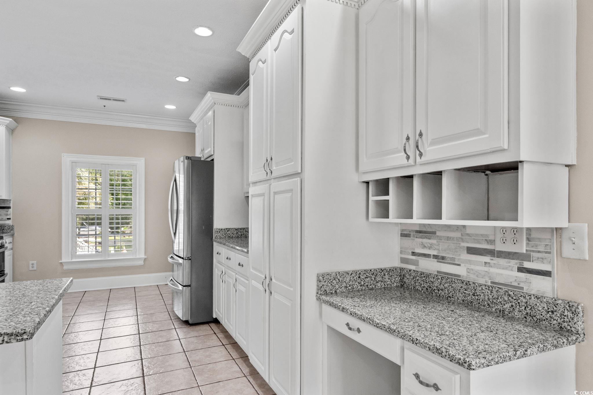 6912 Bay Road Myrtle Beach, SC 29588 - Photo 10 of 38 Kitchen with backsplash, white cabinets, crown molding, and recessed lighting