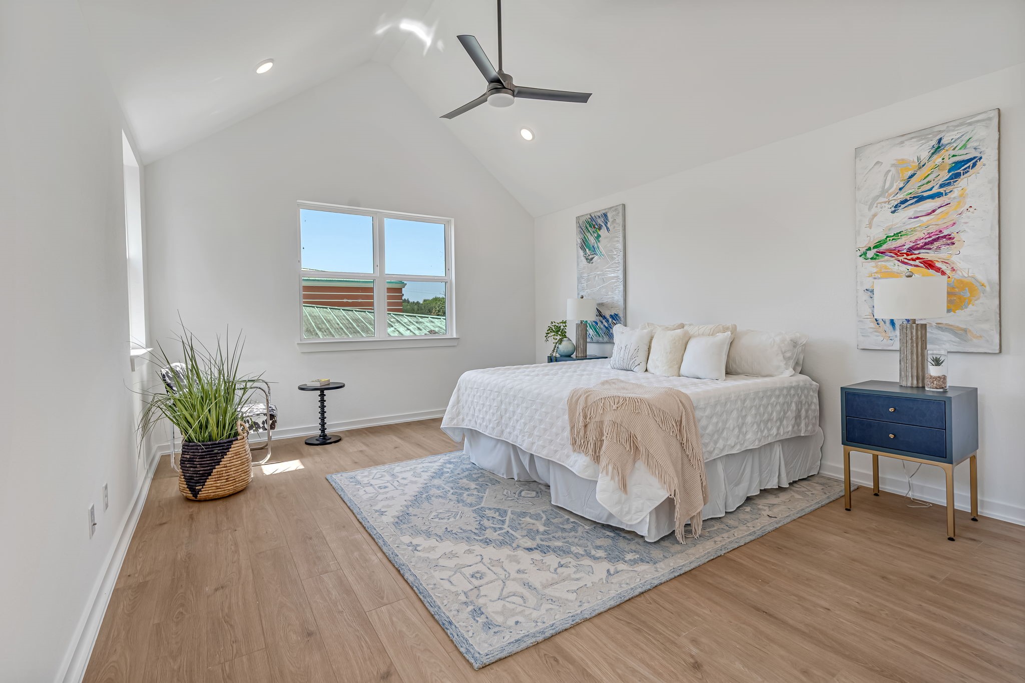 3620 Sauer Street, Unit B Houston, TX 77004 - Photo 16 of 31 a bedroom with a large bed a chandelier and a potted plant