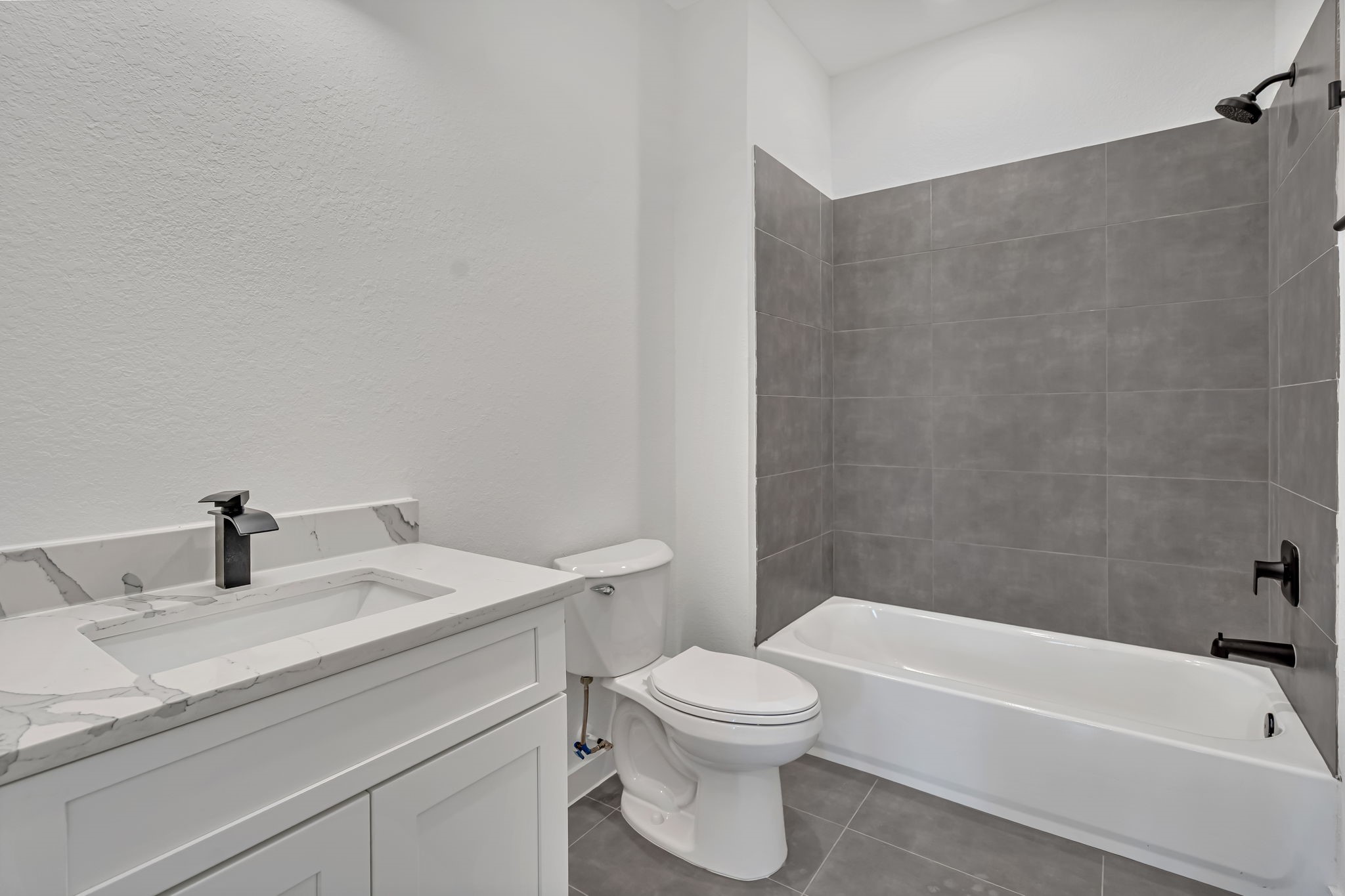 3620 Sauer Street, Unit B Houston, TX 77004 - Photo 27 of 31 a bathroom with a granite countertop sink a toilet and bathtub
