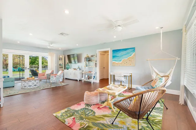 a living room with furniture and wooden floor