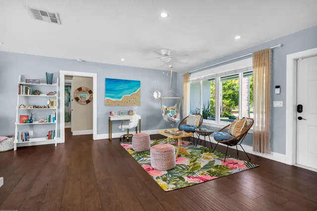 a view of a dining room with furniture a chandelier and wooden floor