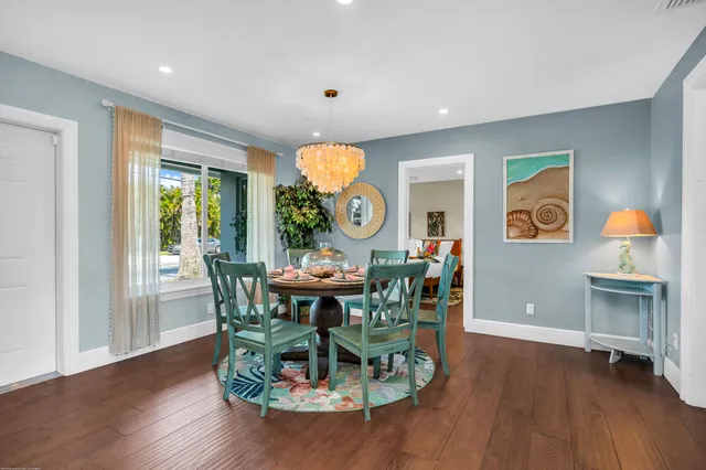 a spacious bedroom with a bed and wooden floor
