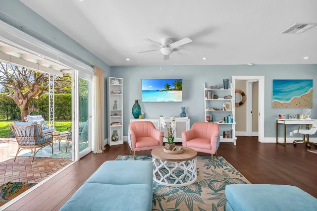 a kitchen with stainless steel appliances granite countertop a sink a stove a refrigerator cabinets and living room view