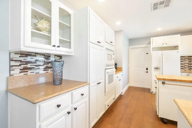 a bedroom with a bed and a table in it with wooden floor