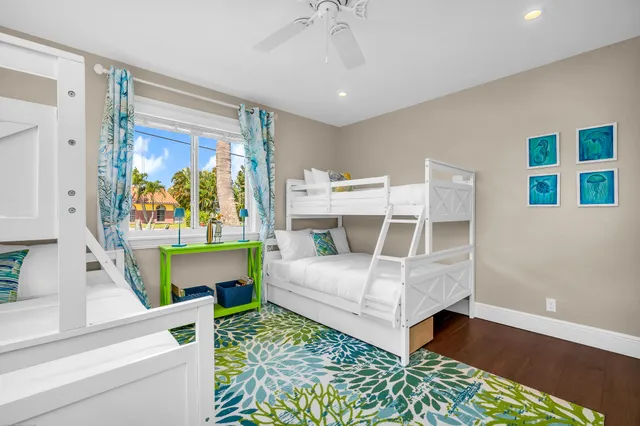 a bedroom with a bed and a lamp on dresser