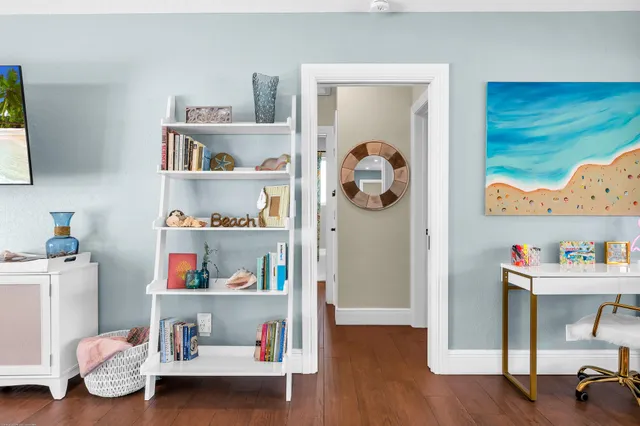a view of a backyard with table and chairs under an umbrella