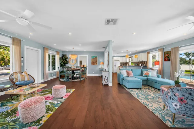 a living room with furniture and wooden floor