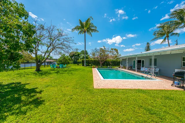 a view of a house with a yard porch and sitting area