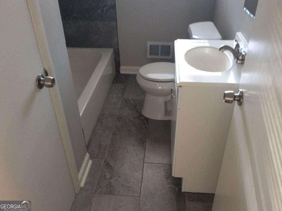 209 Decatur Road McDonough, GA 30253 - Photo 21 of 33 a bathroom with a toilet and a sink