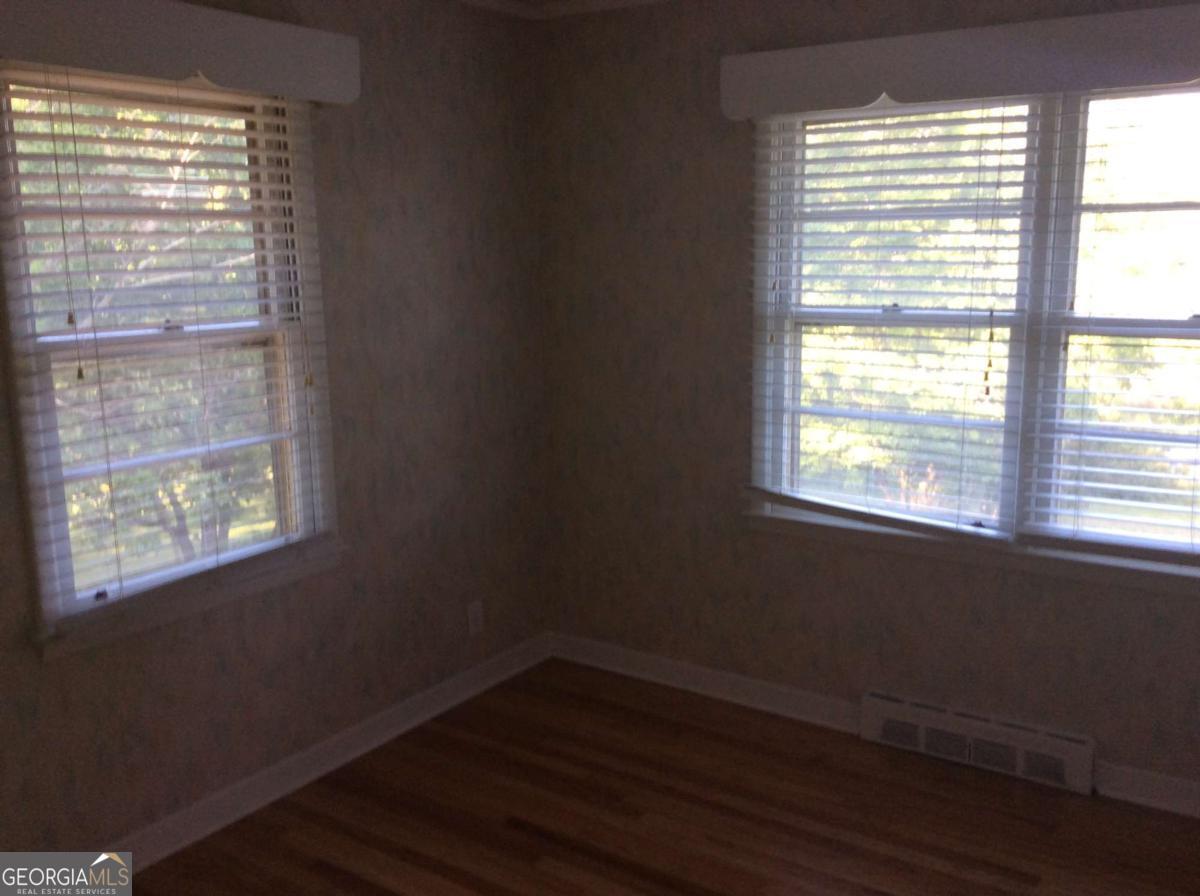 209 Decatur Road McDonough, GA 30253 - Photo 26 of 33 a view of an empty room with wooden floor and a window