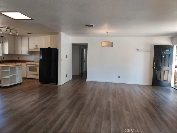 a kitchen with white cabinets and white appliances