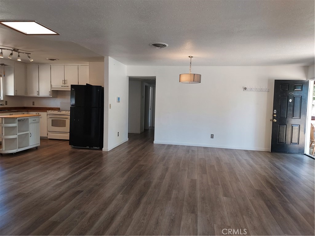 6135 Ridgeview Drive Clearlake, CA 95422 - Photo 14 of 36 a view of a kitchen with refrigerator and wooden floor