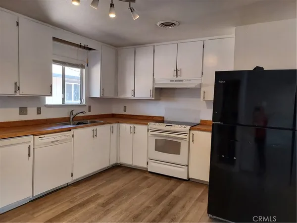 a room that has a sink and a stove in it