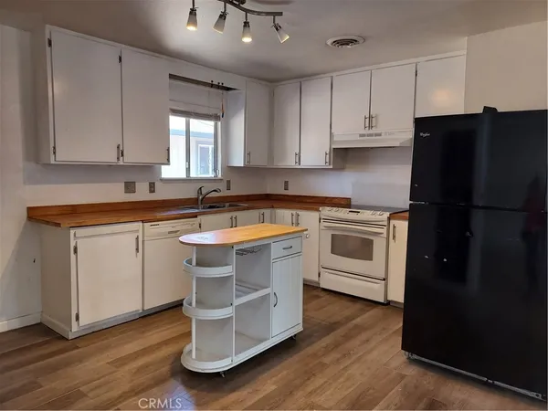 a bathroom with a sink a toilet and shower curtain