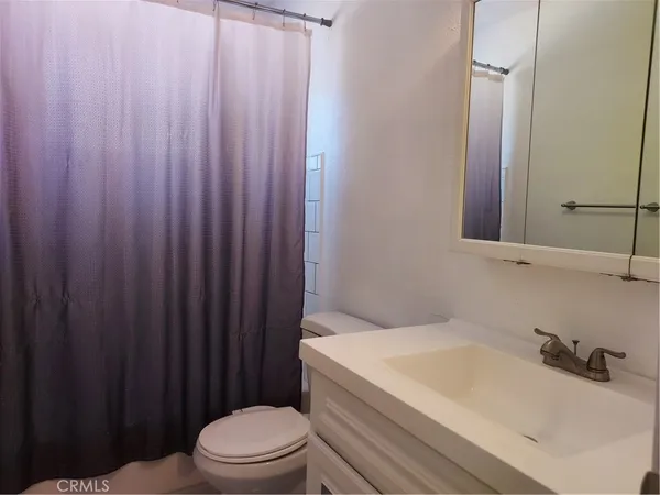 an empty room with closet and chandelier fan
