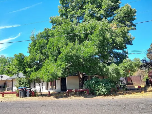 a couple of table and chairs in front of house