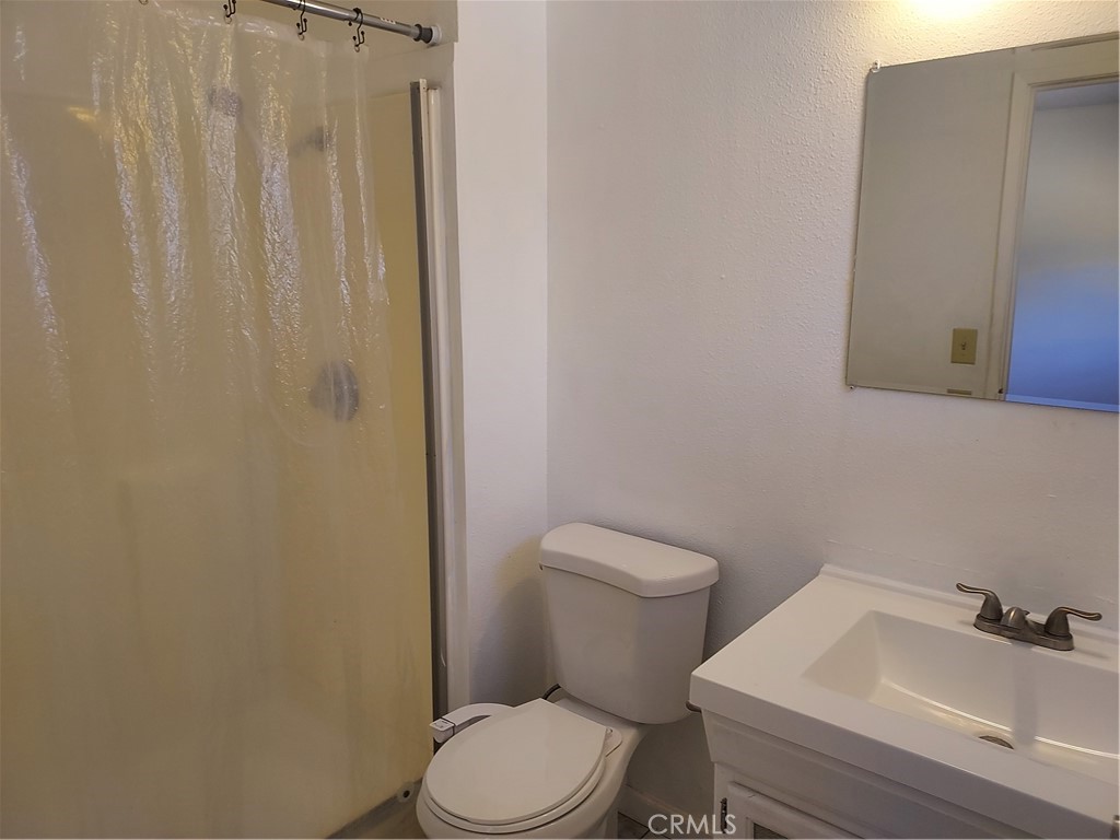 6135 Ridgeview Drive Clearlake, CA 95422 - Photo 26 of 36 a white toilet sitting next to a bathroom sink