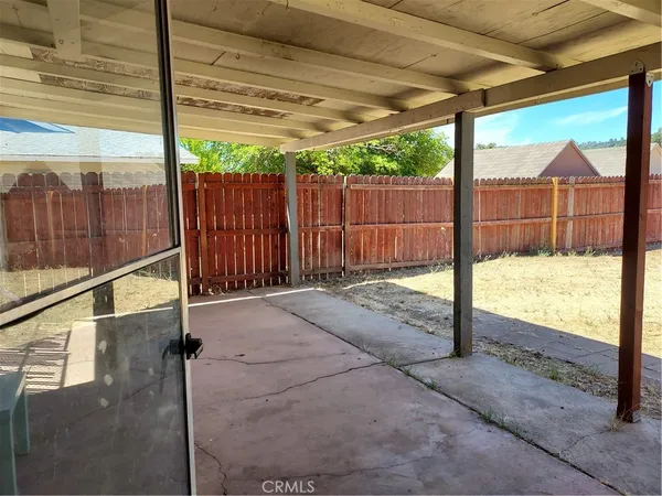 a view of wooden fence and a yard