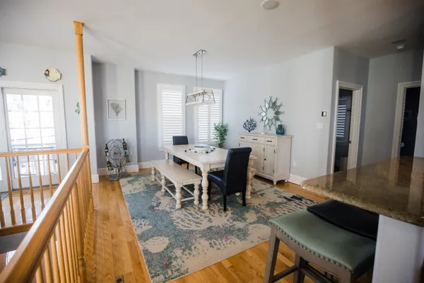 a view of a dining room with furniture window and wooden floor