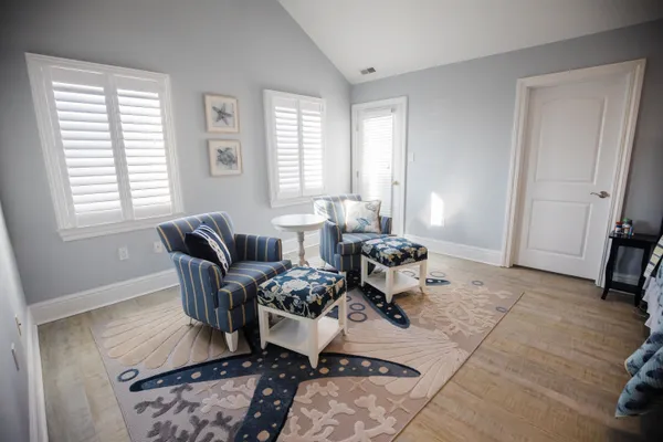 a bedroom with a bed couch and window